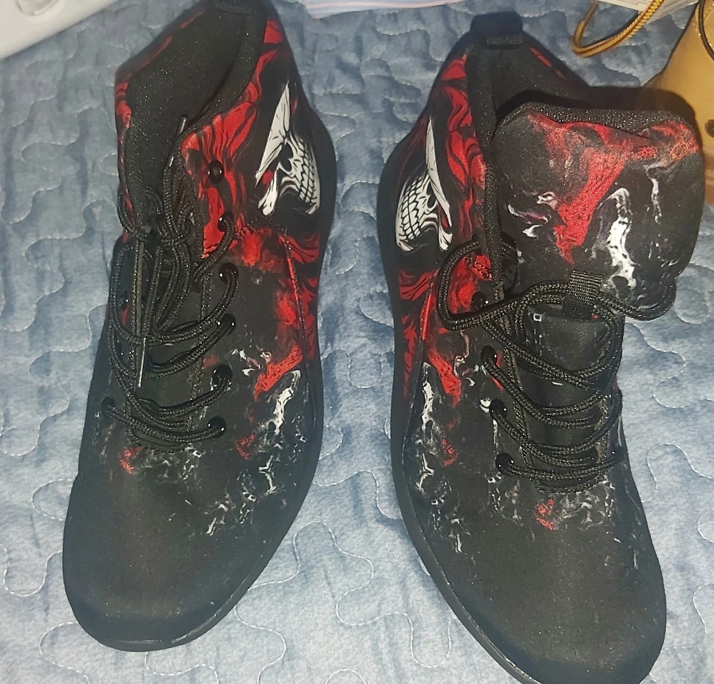 Red and black skull print high top sneakers