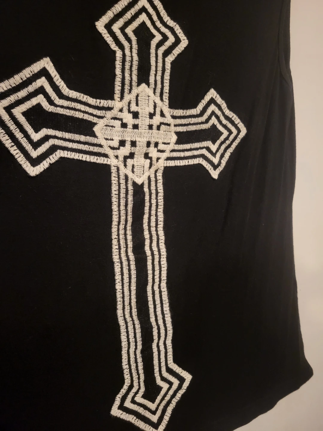 Black sleeveless top with embroidered cross design - photo 2