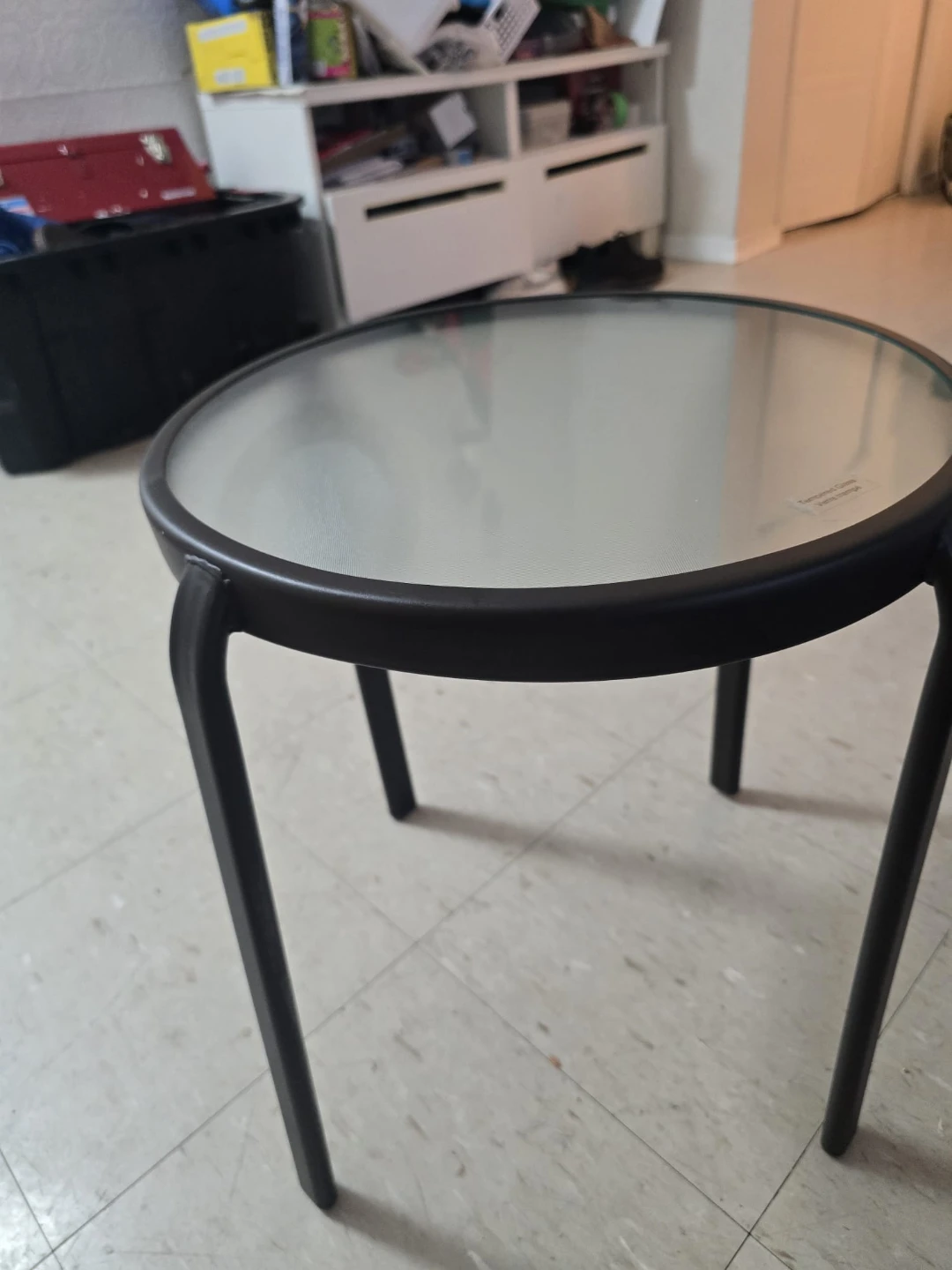 Set of 2 White Metal Stools and one black round glass table