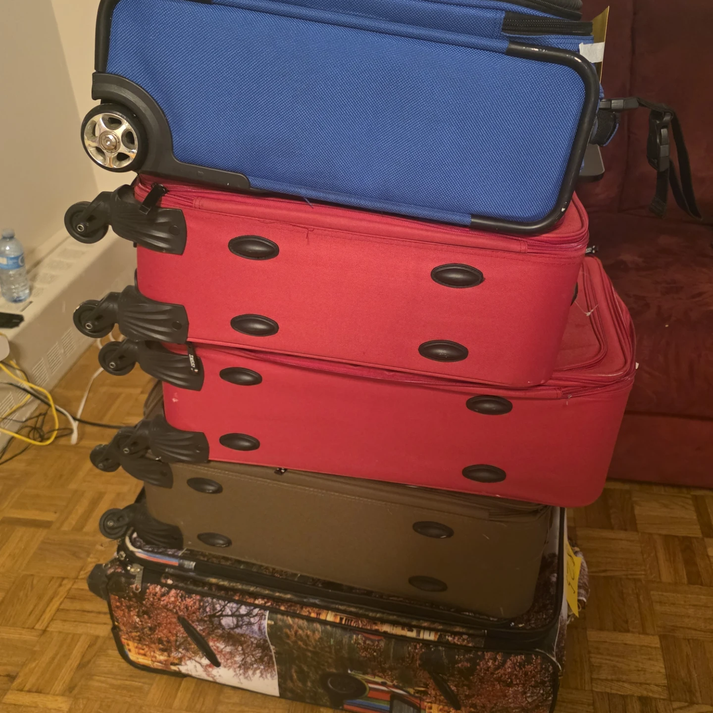 Stack of Luggage - Blue, Red, Brown, and Printed Suitcases