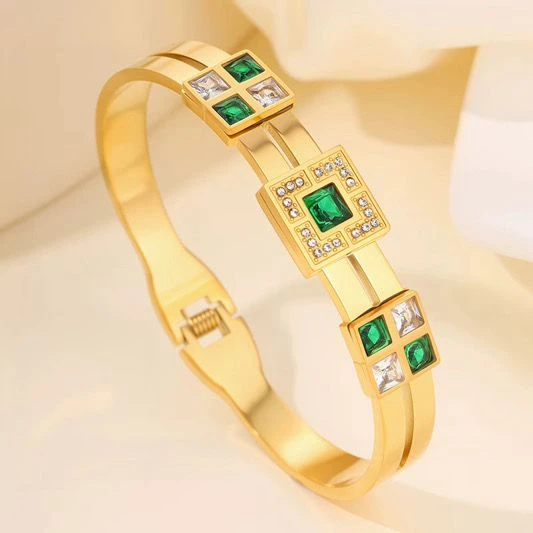 Gold tone bracelet with green and clear stones