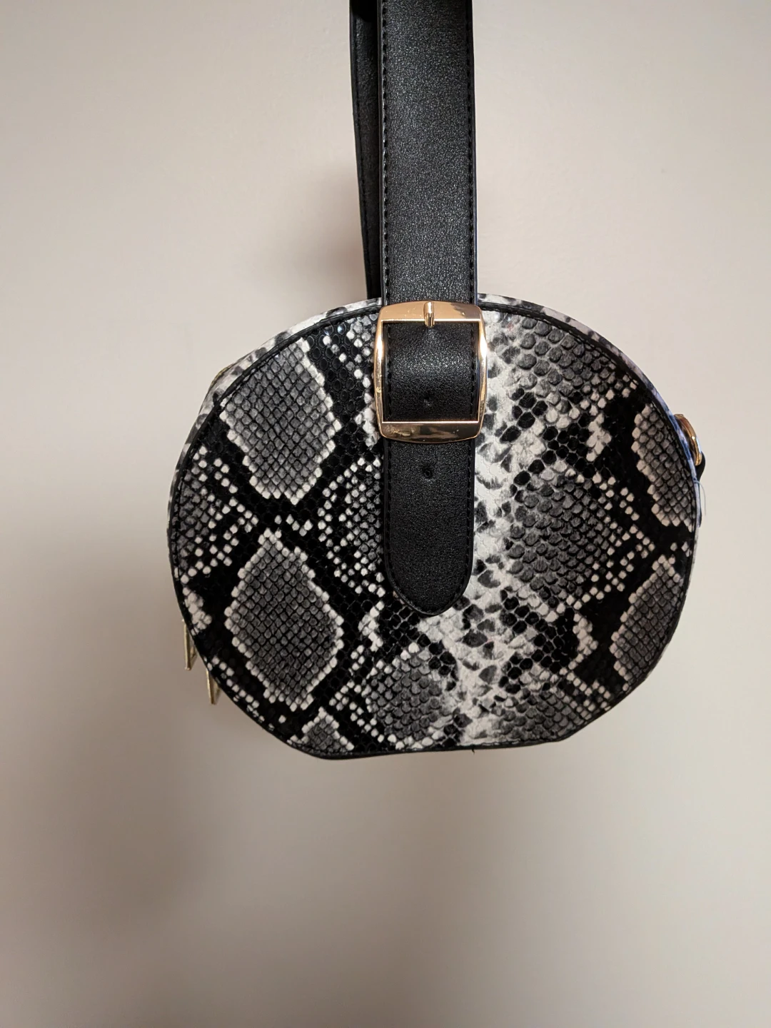 Round black and white python patterned bag