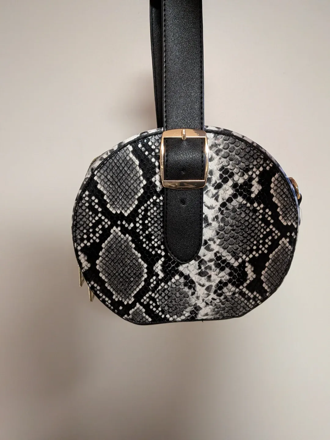 Round black and white python patterned bag