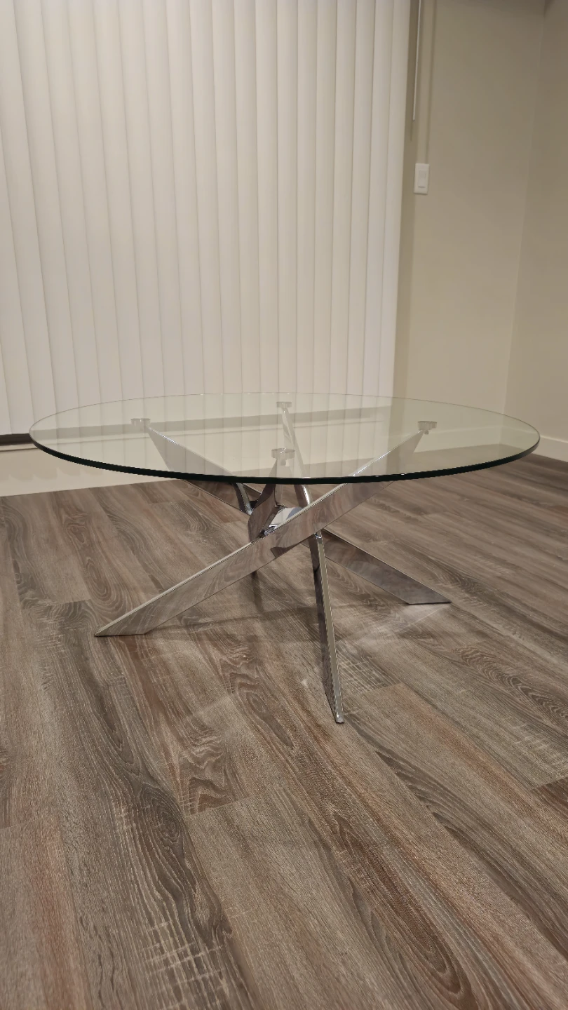 Round glass coffee table with chrome base
