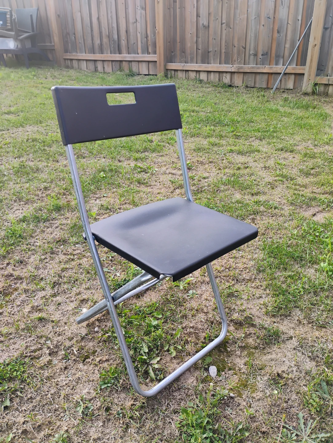 Four black Ikea folding chairs