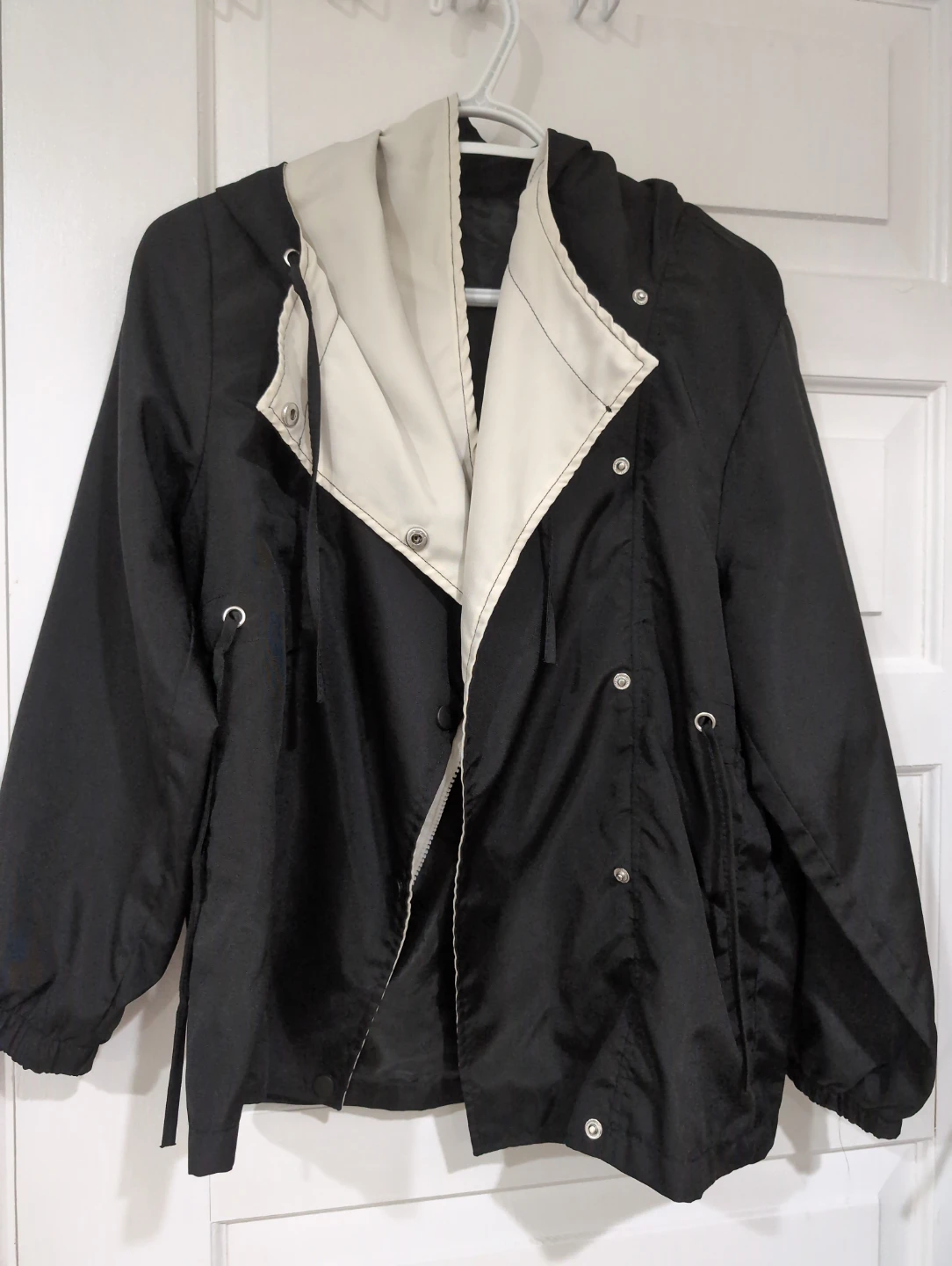 Black hooded windbreaker jacket