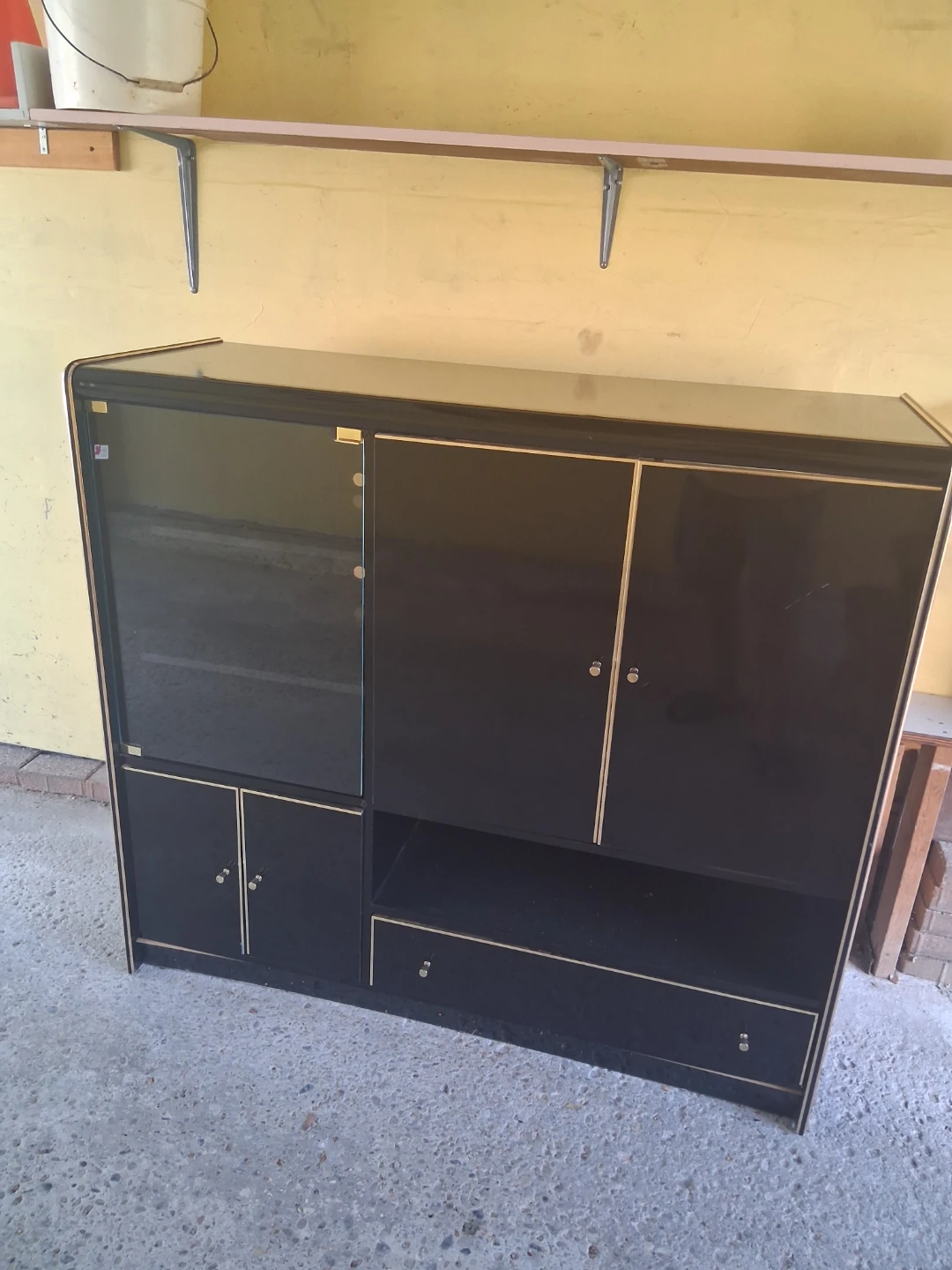 Black and gold cabinet with glass doors