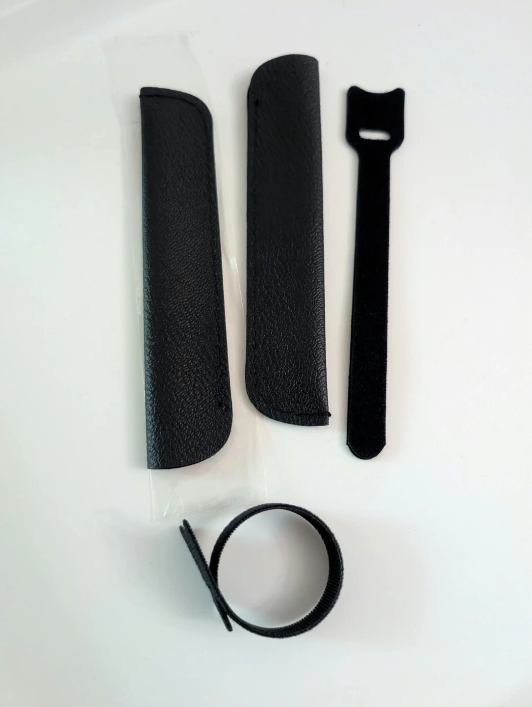 Black stylus pouches and cable organizers