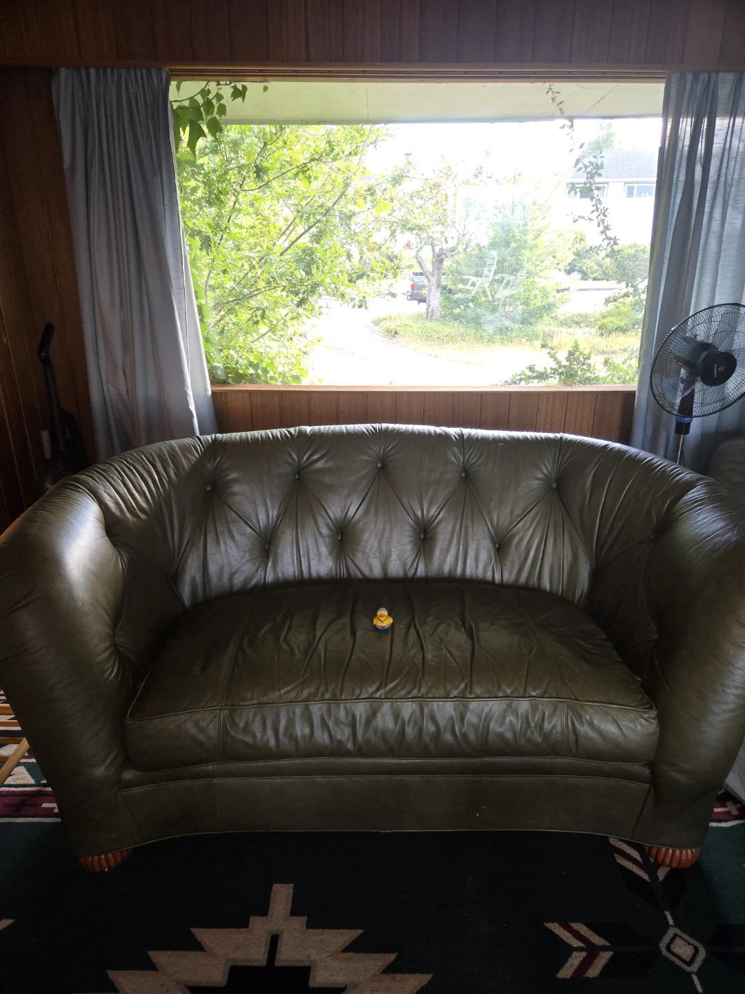 Green tufted leather loveseat