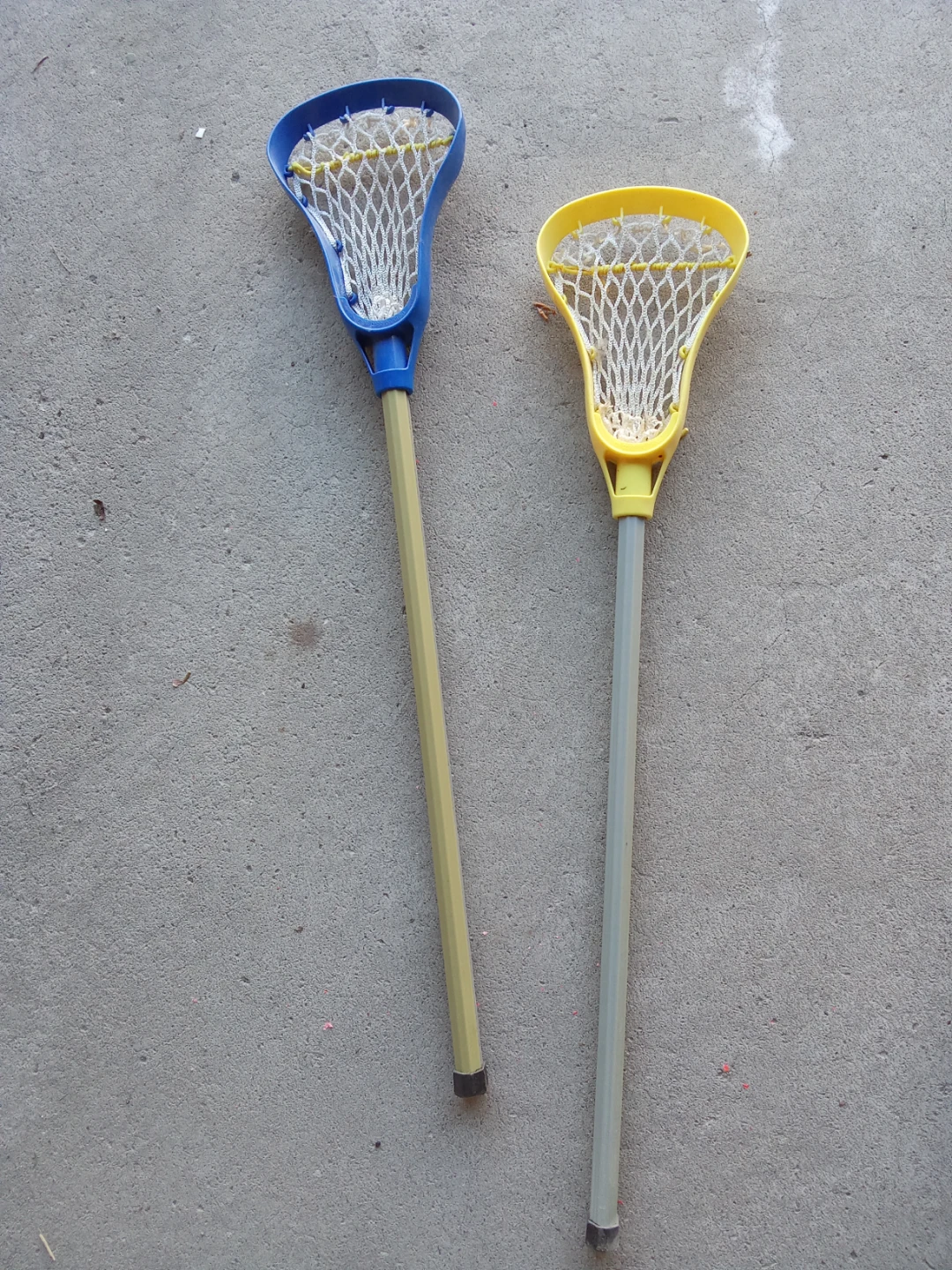 Set of two lacrosse sticks in blue and yellow