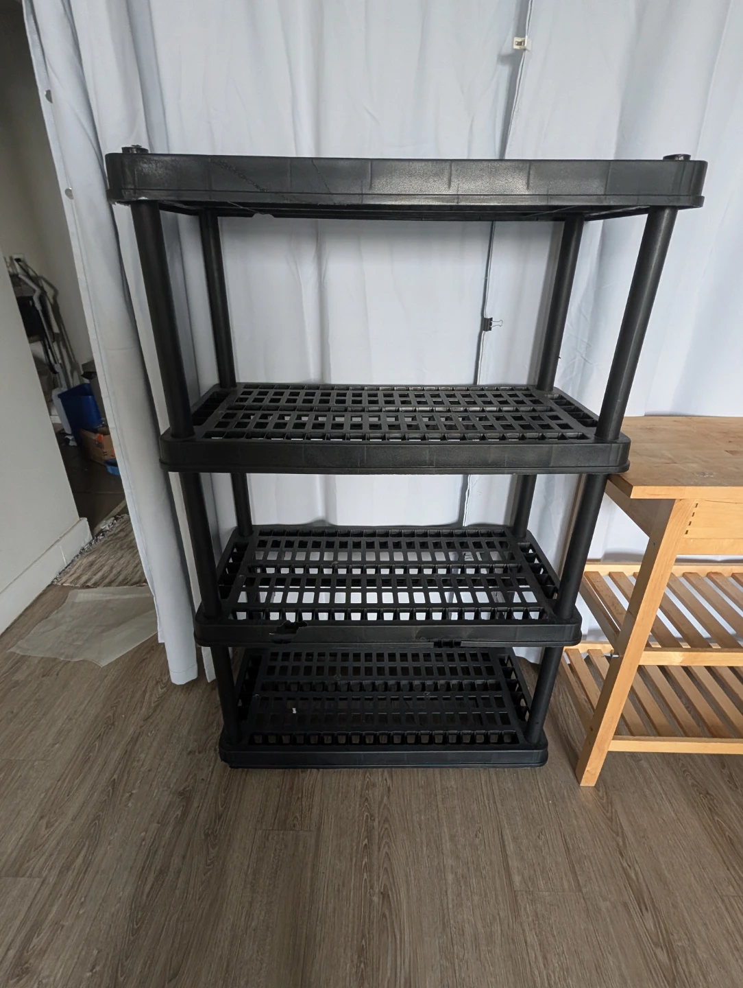 Plastic rack, IKEA wobbly kitchen table, and plastic rack