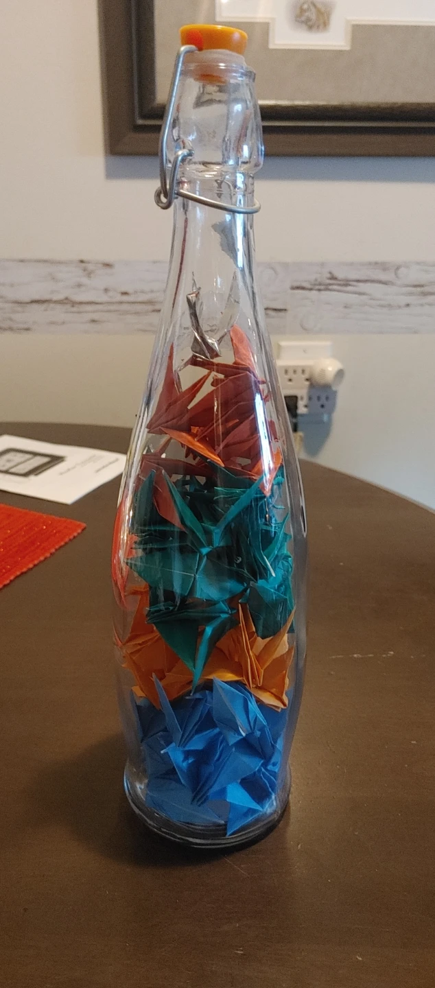 Glass bottle with origami cranes