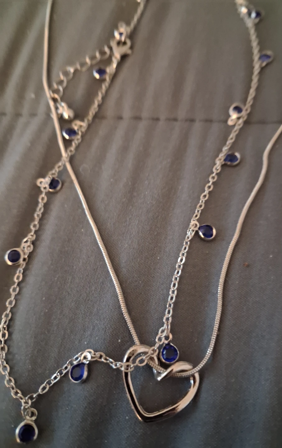 Silver-tone layered necklace with blue accents and heart pendant