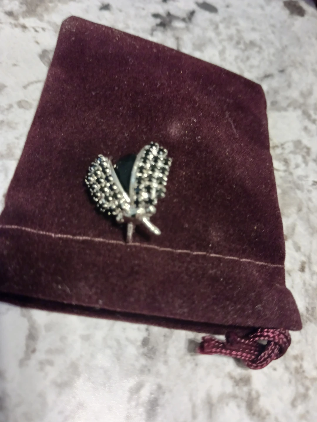 Silver tone butterfly brooch with black accents