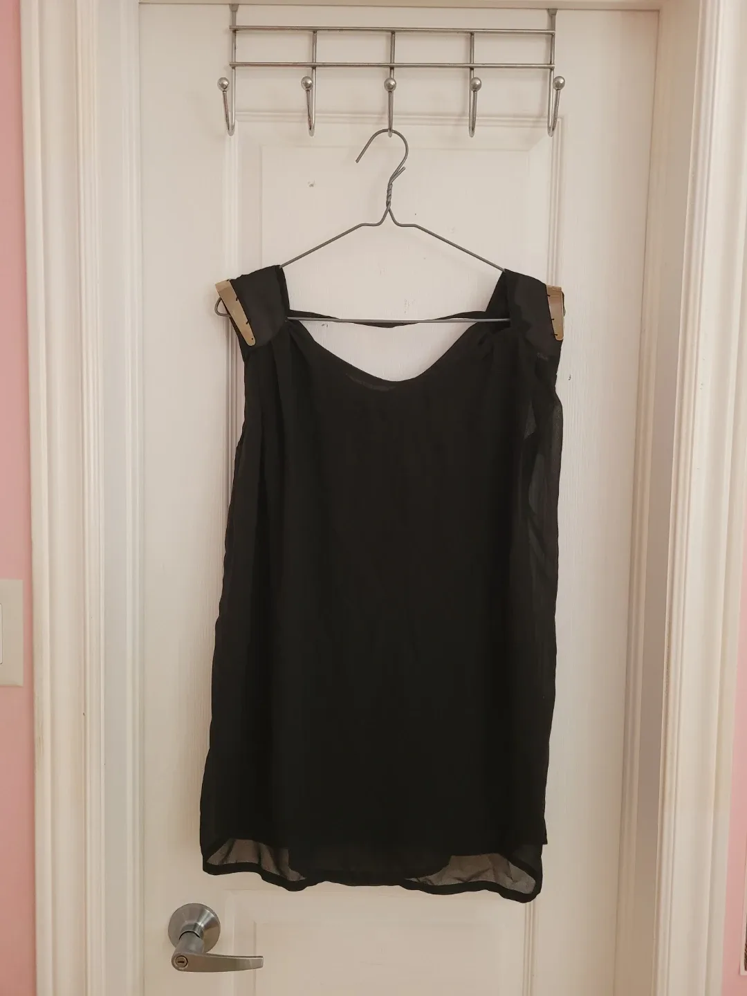Black sleeveless top with gold accents