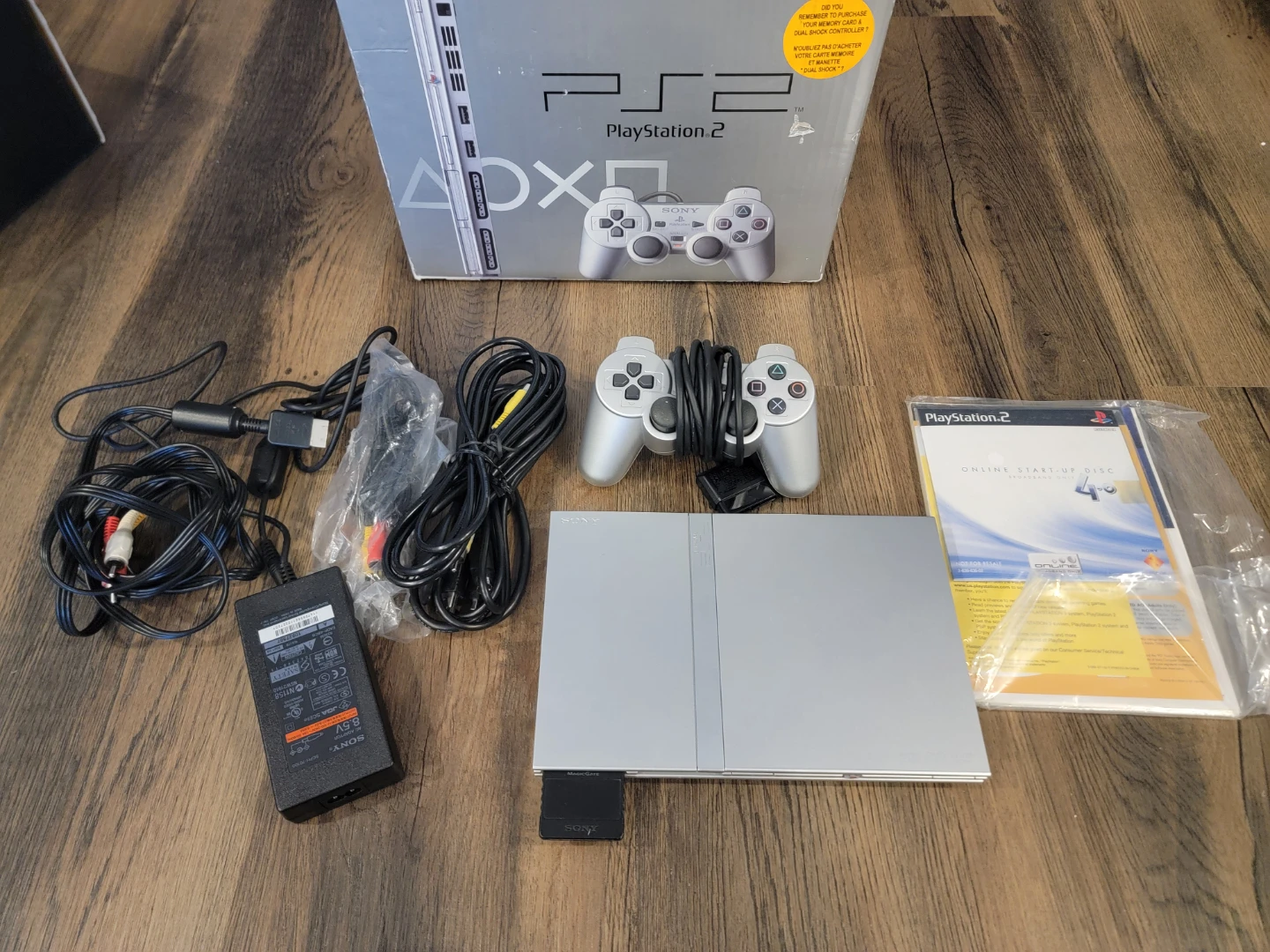 Silver Sony PlayStation 2 Slim Version with games