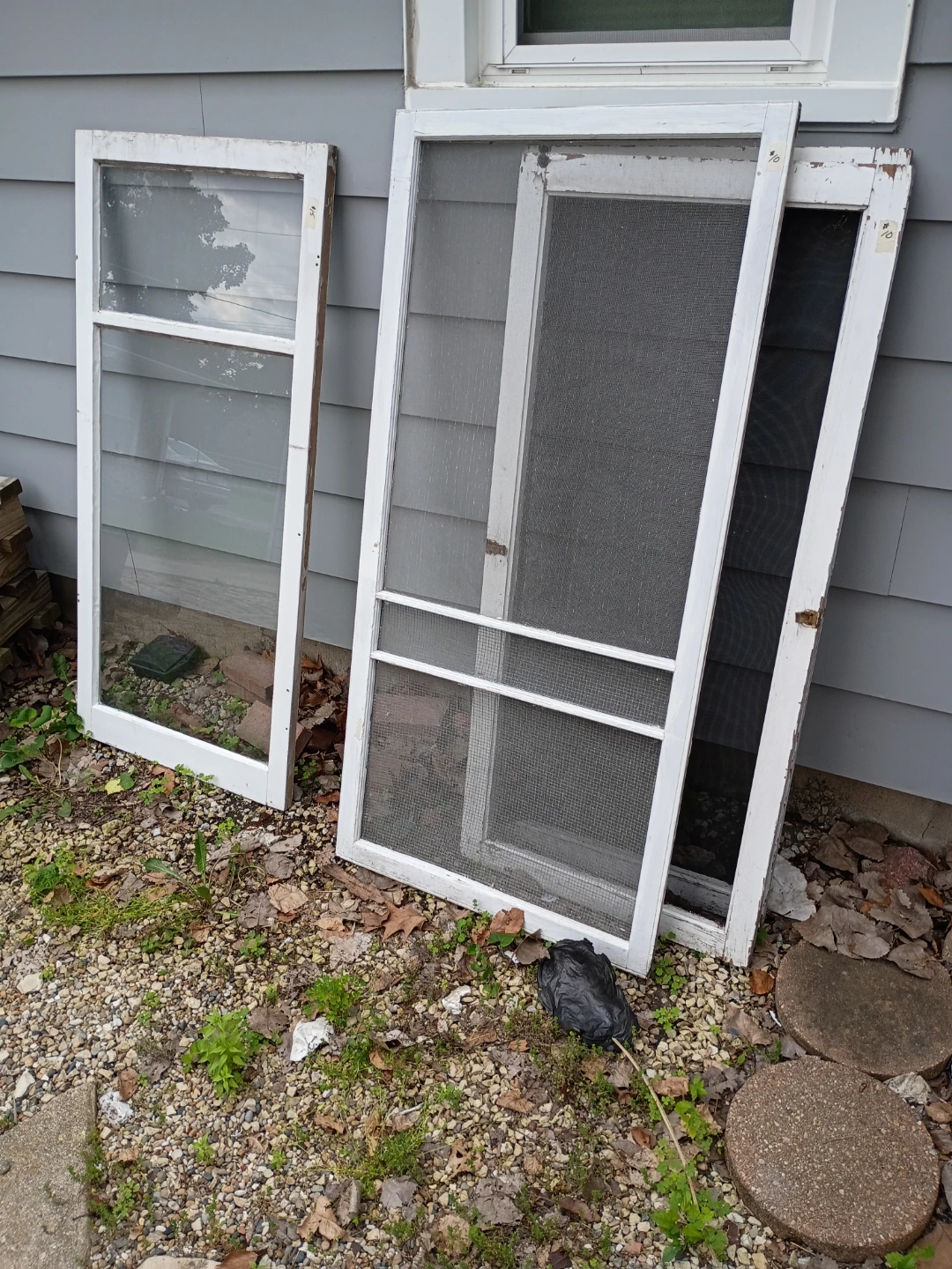 Three vintage window screens and one window