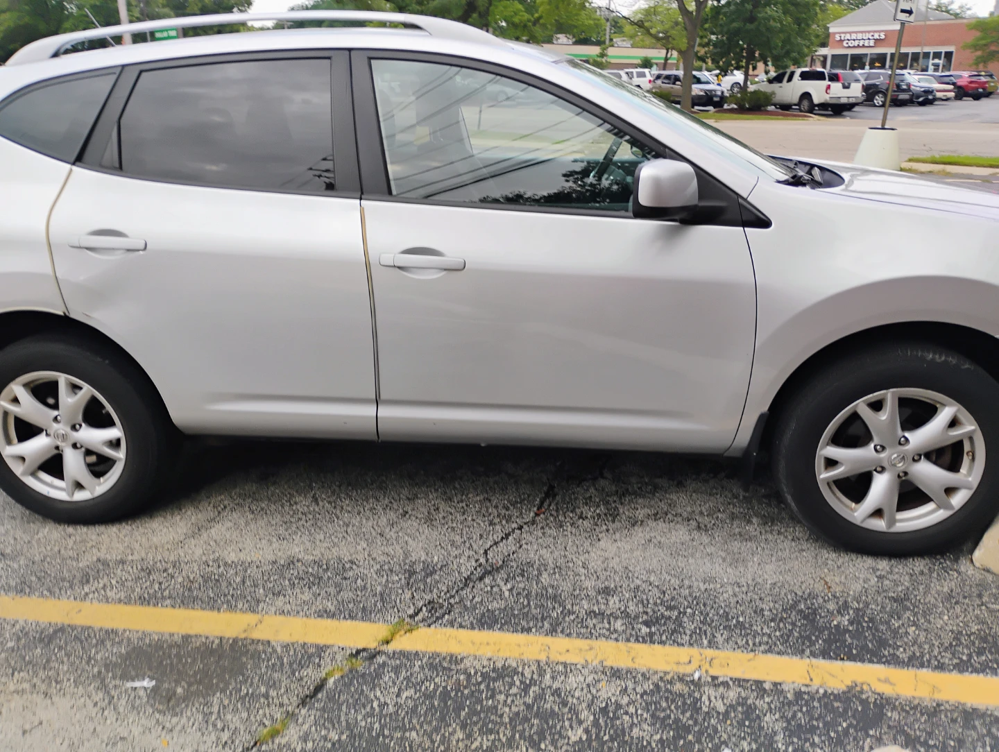 Silver Nissan Rogue SUV - photo 2
