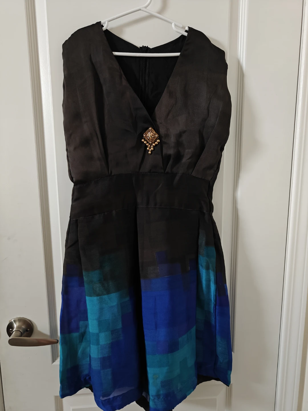 Black sleeveless dress with blue and teal gradient hem