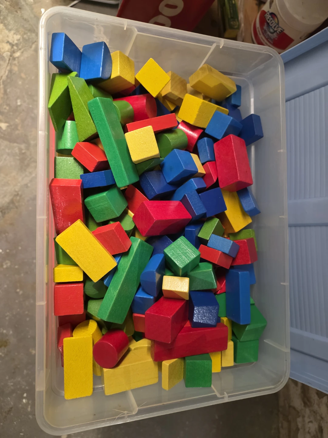 Assorted multicolour wooden building blocks with bin