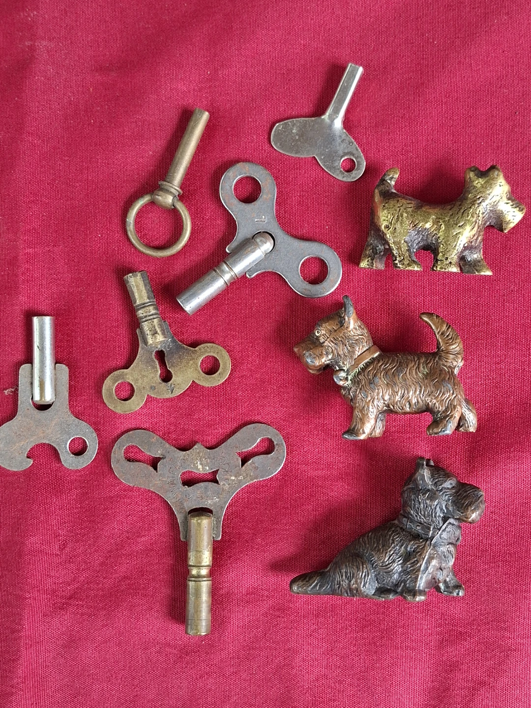 Lot of antique wind-up keys and dog figurines