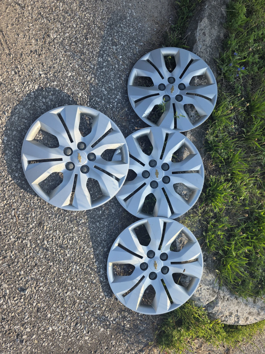 Set of 4 Chevrolet Hubcaps and 1 Spare Tire