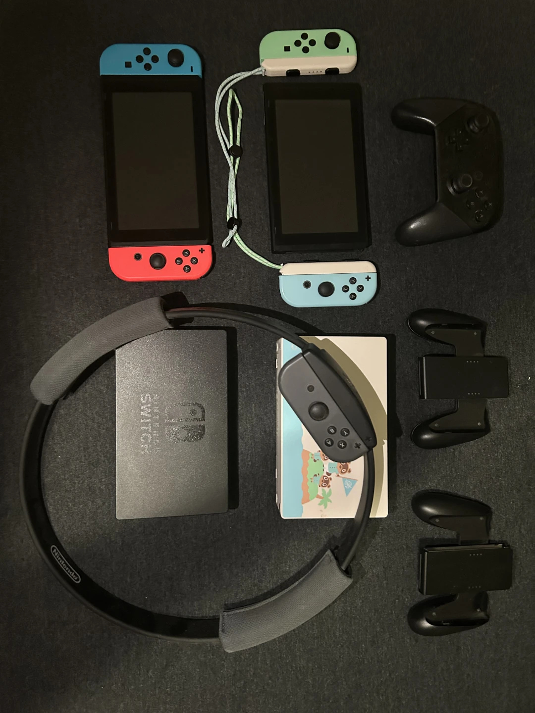 2 Nintendo Switches, 7 games, and case with controllers.