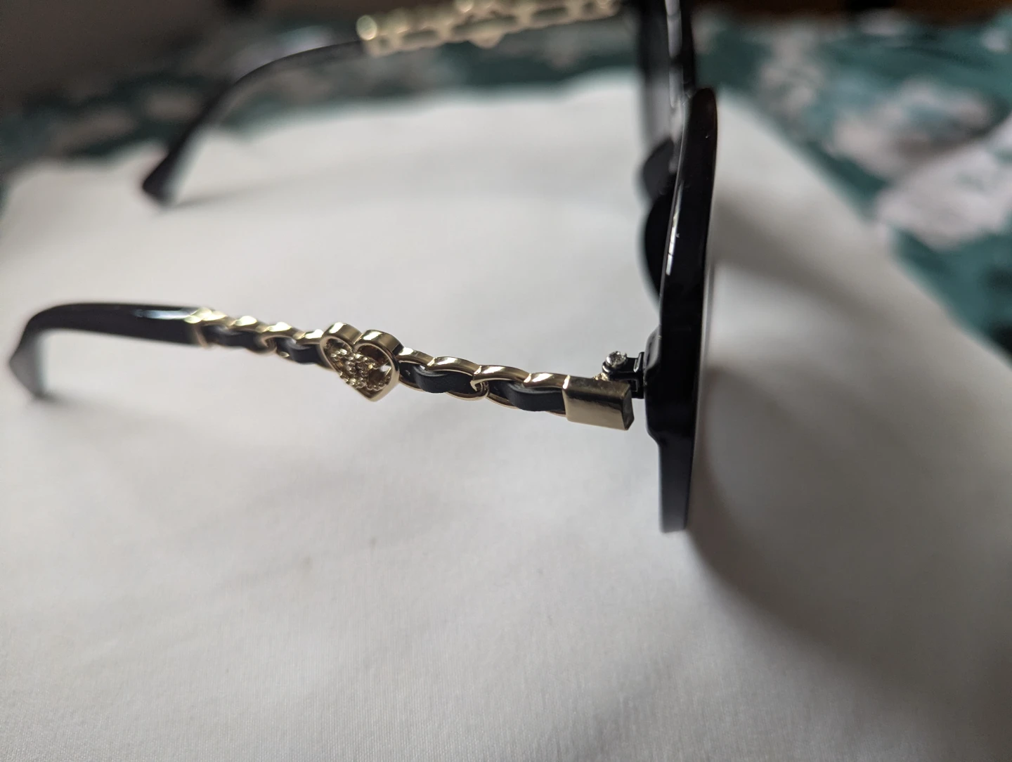 CHANEL Black Cat-Eye Sunglasses with Gold Chain Detail