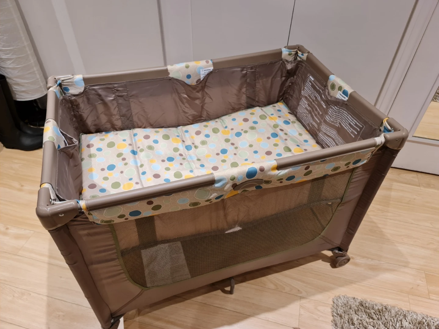 Brown Playpen with Multi-coloured Circles