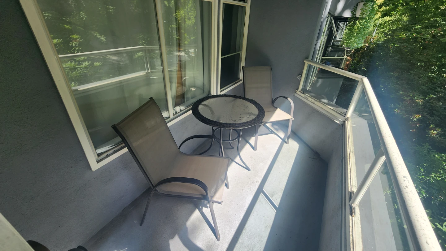 Round Glass Top Wicker Patio Table with two chairs