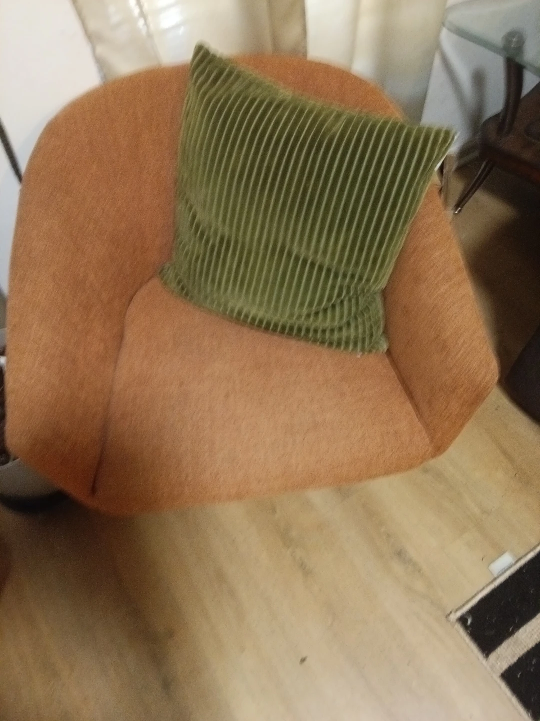 Orange Upholstered Armchair with Green Pillow