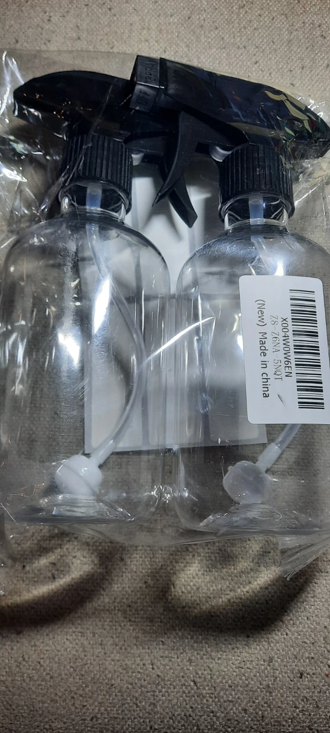 Set of 2 clear small plastic spray bottles with labels