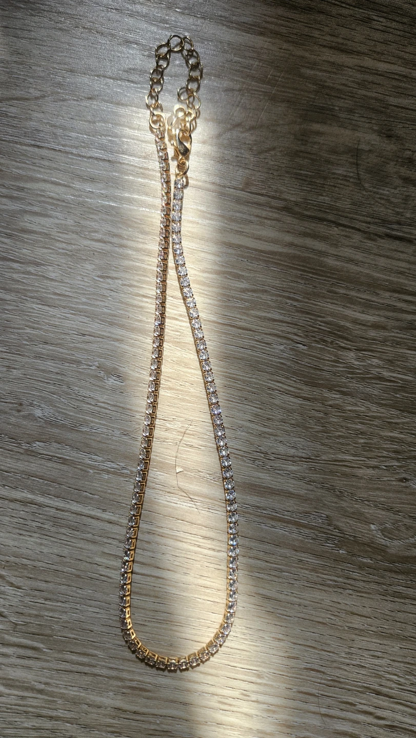 Gold tone tennis necklace with clear rhinestones