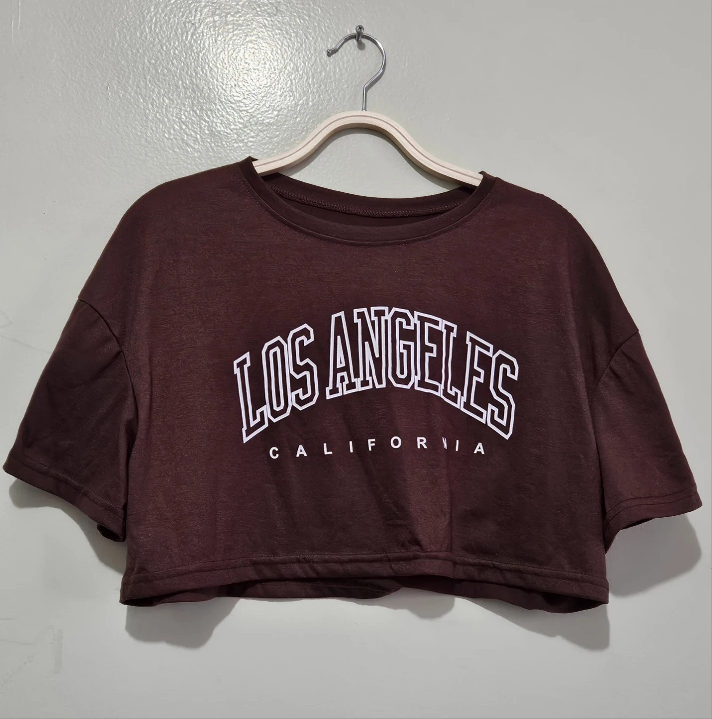 Cropped Dark Brown Short-Sleeved Graphic T-Shirt.