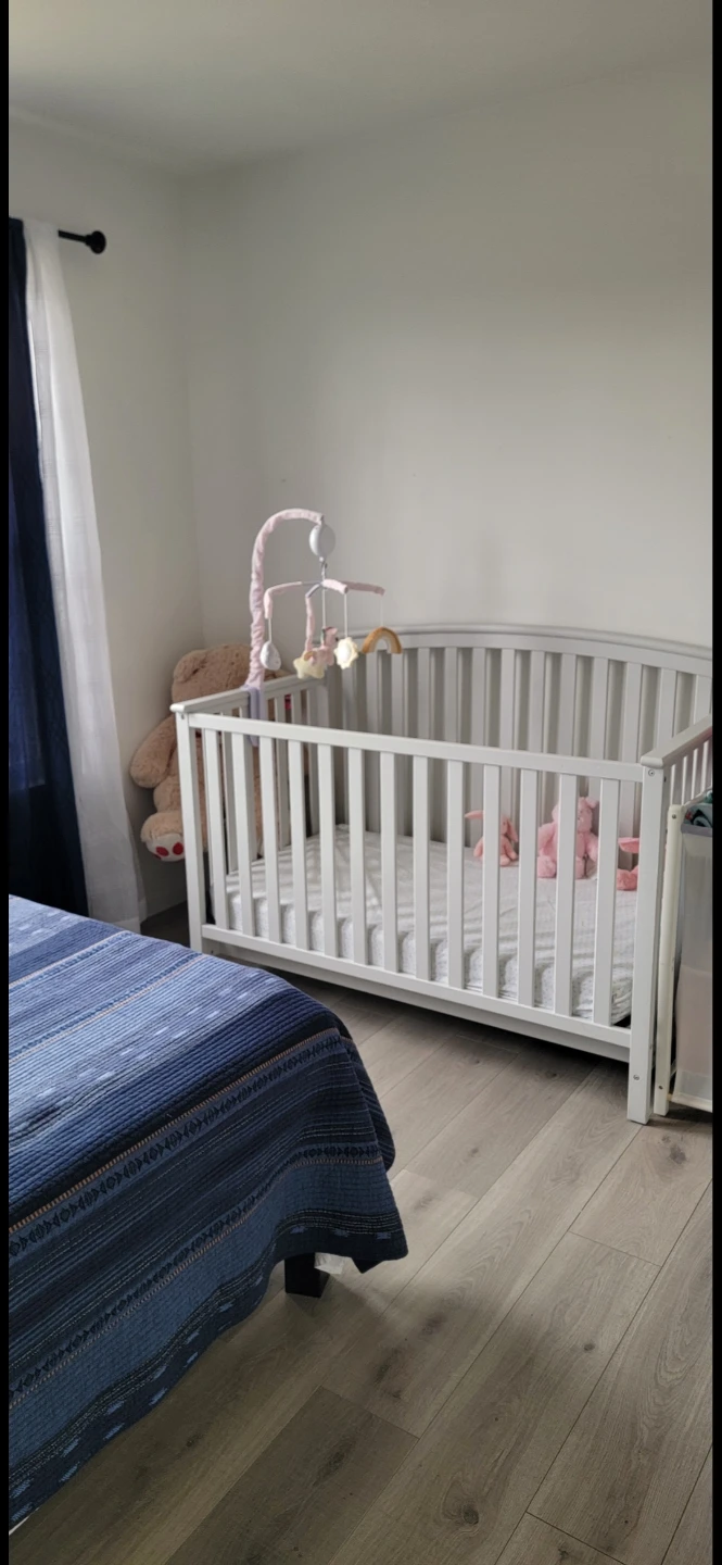 Light Gray Crib with Grey Bumper Pads