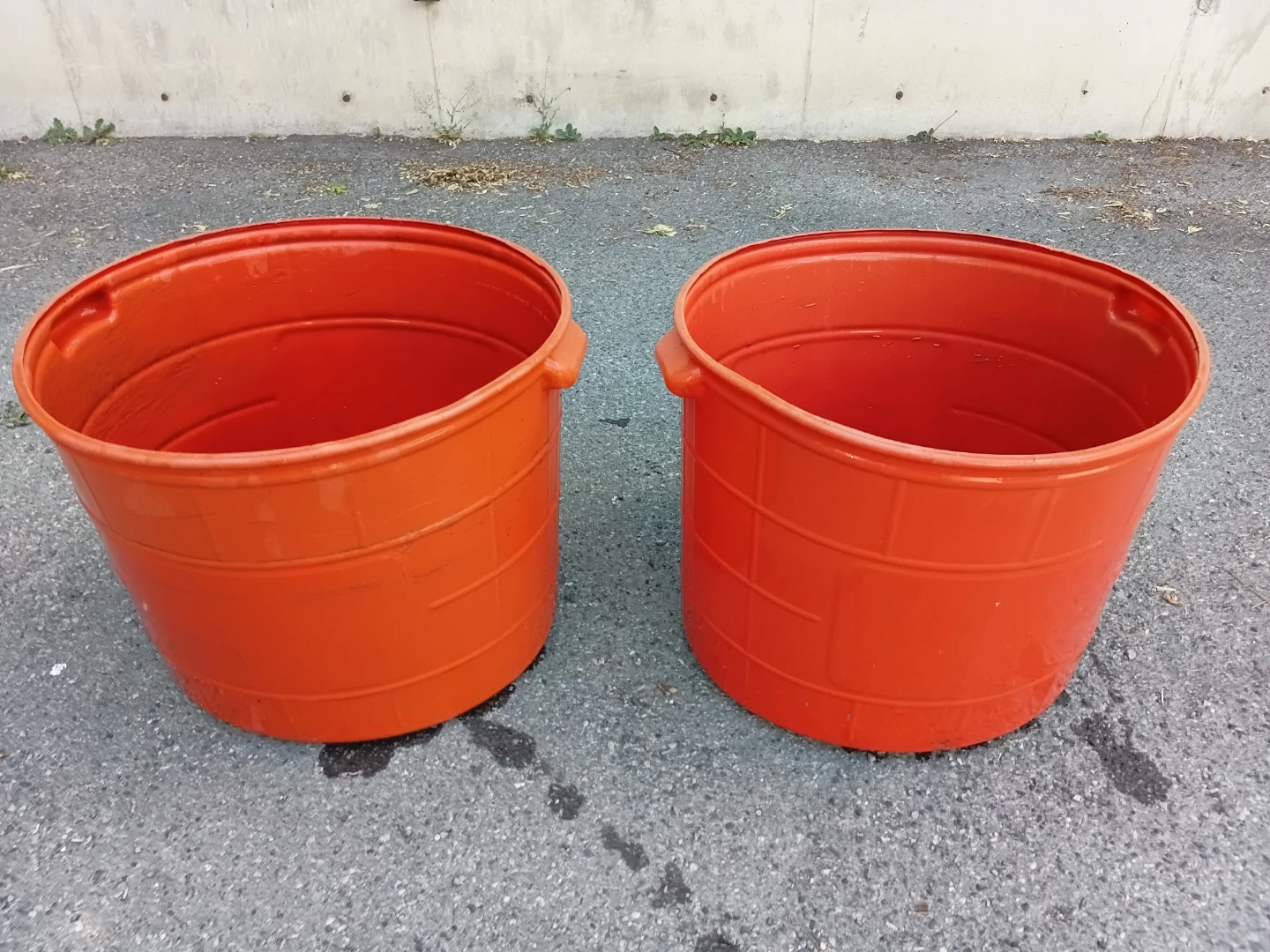 Two Orange Industrial Rain Buckets