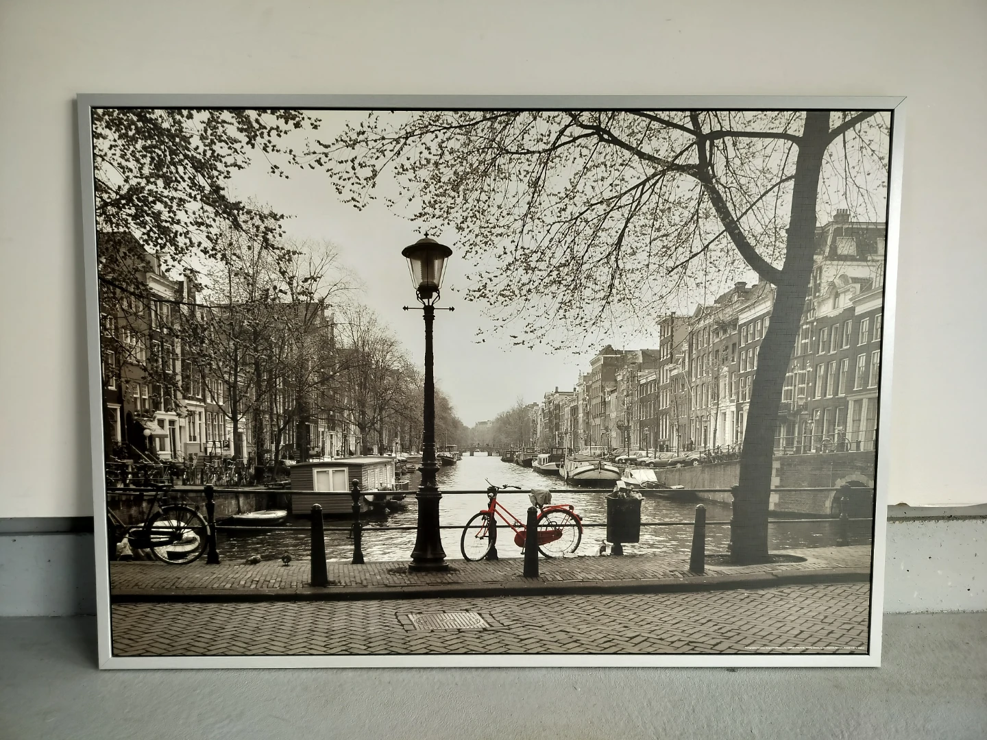 Framed black and white print of Amsterdam canal scene