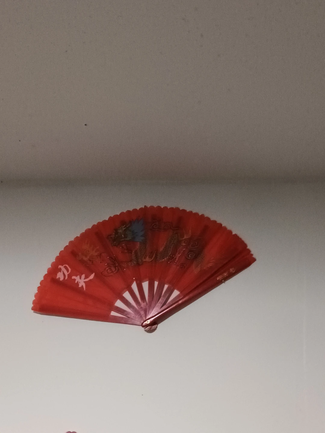 Red folding fan with dragon design