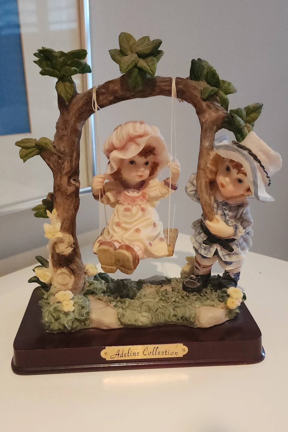 Adeline's Collection figurine of two children on a swing