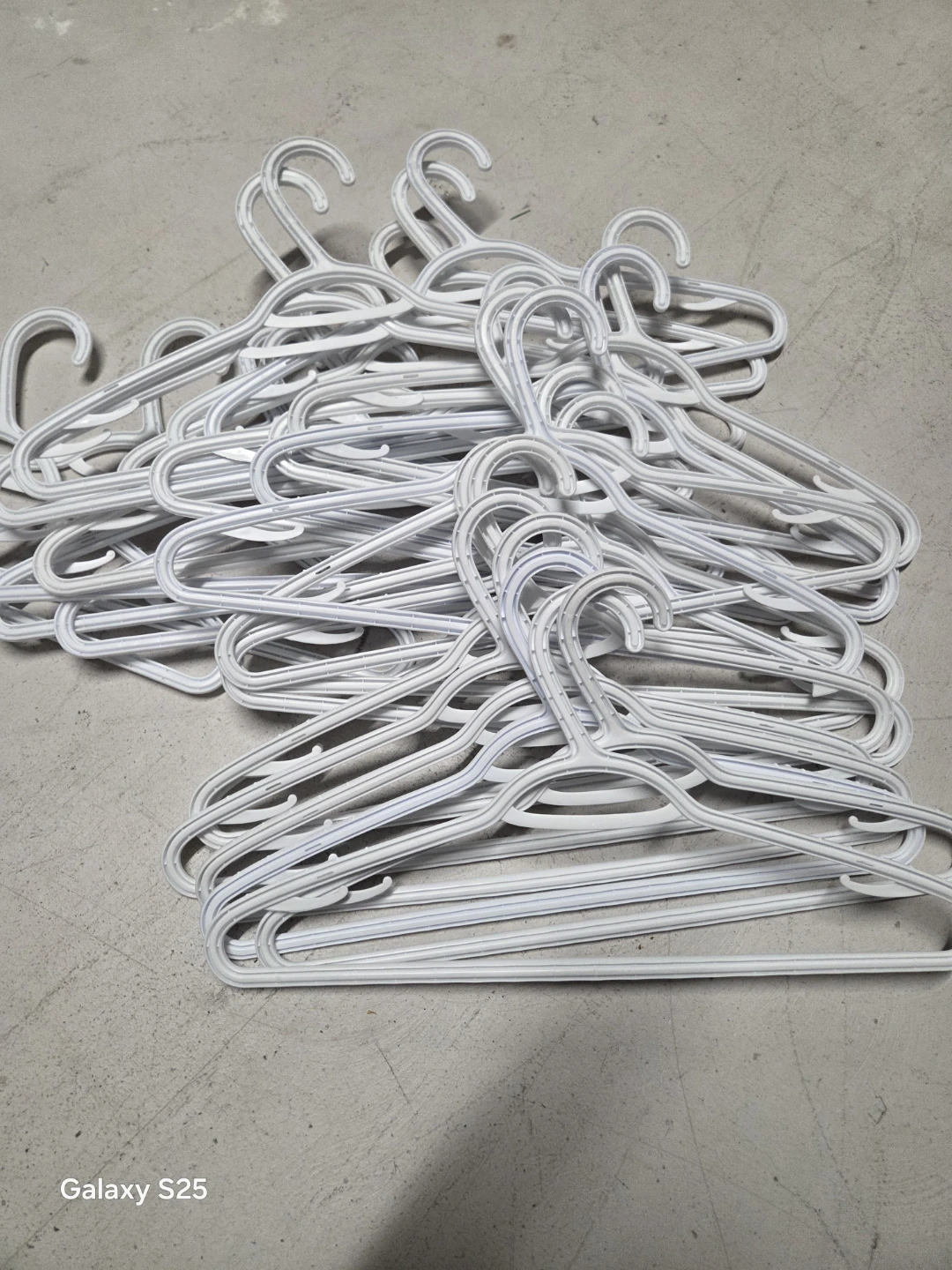 Pile of White Plastic Hangers