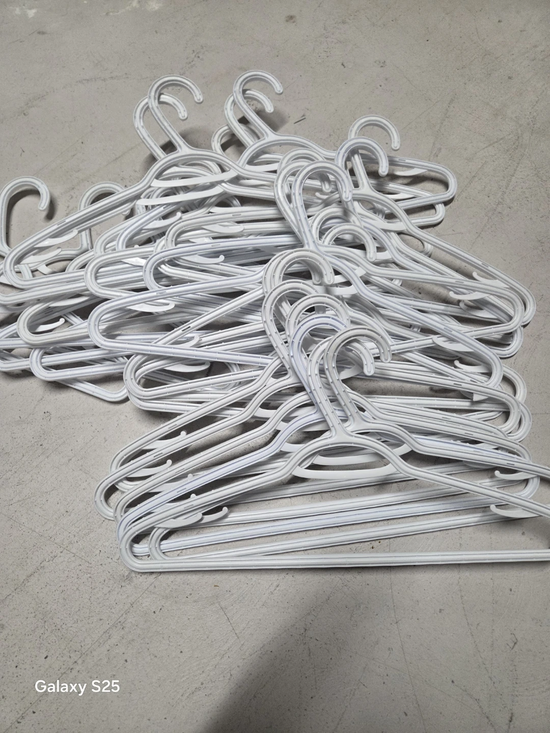 Pile of White Plastic Hangers - photo 2
