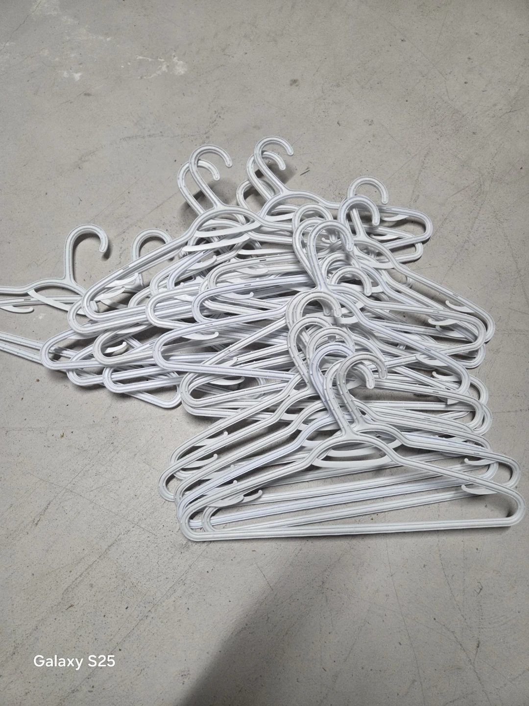 Pile of White Plastic Hangers - photo 4