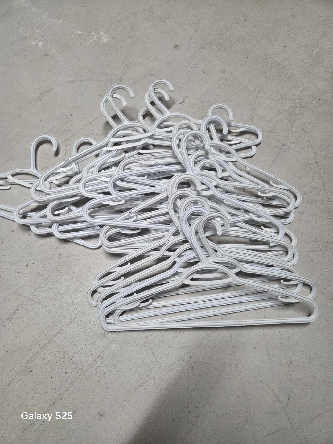 Pile of White Plastic Hangers - photo 5