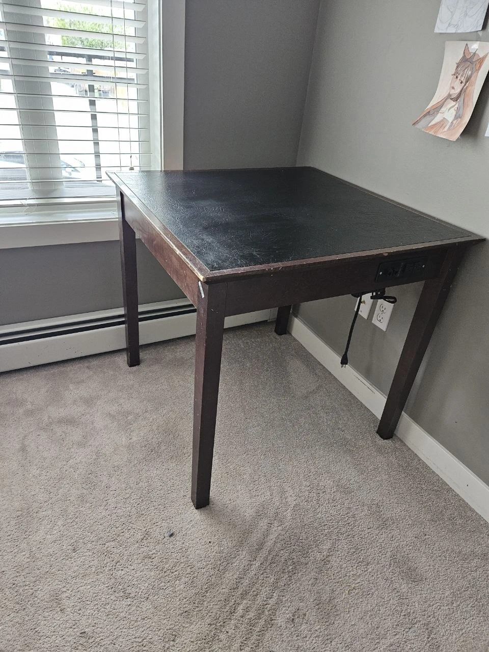 Dark wood desk with built-in power outlets