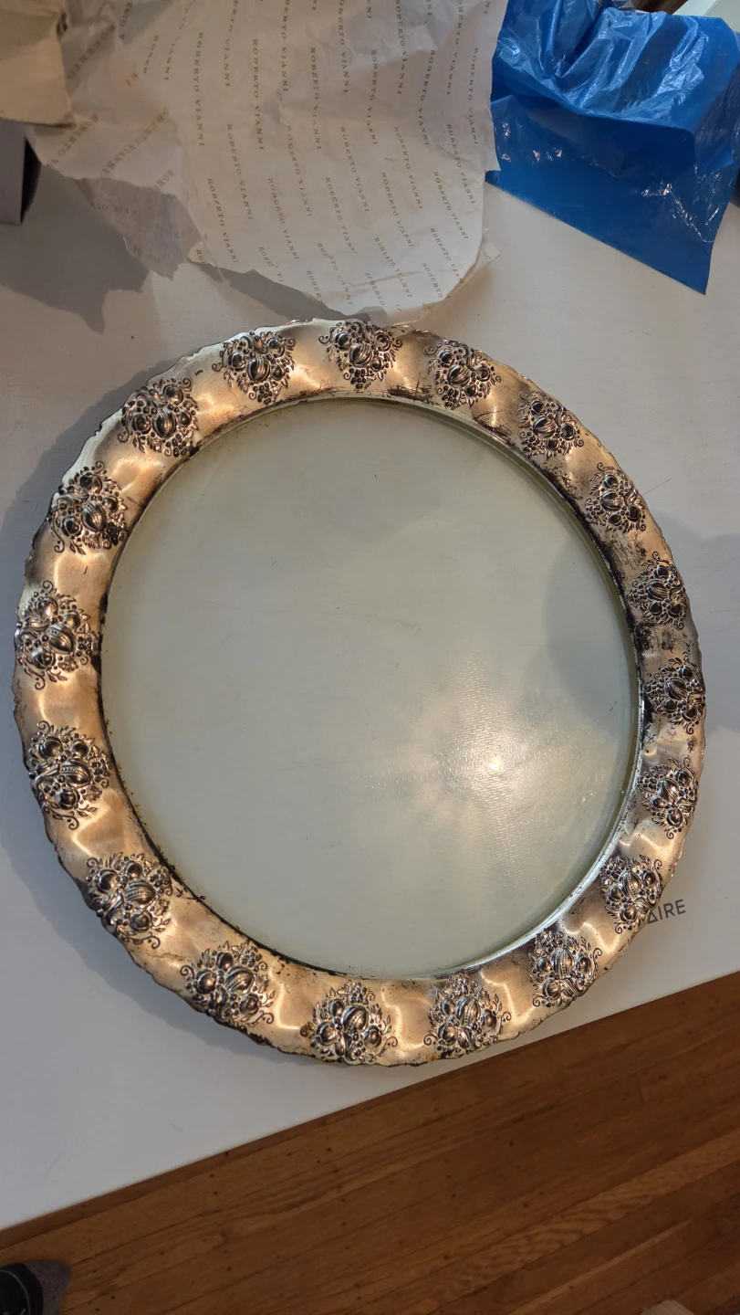 Silver-toned round platter with decorative rim