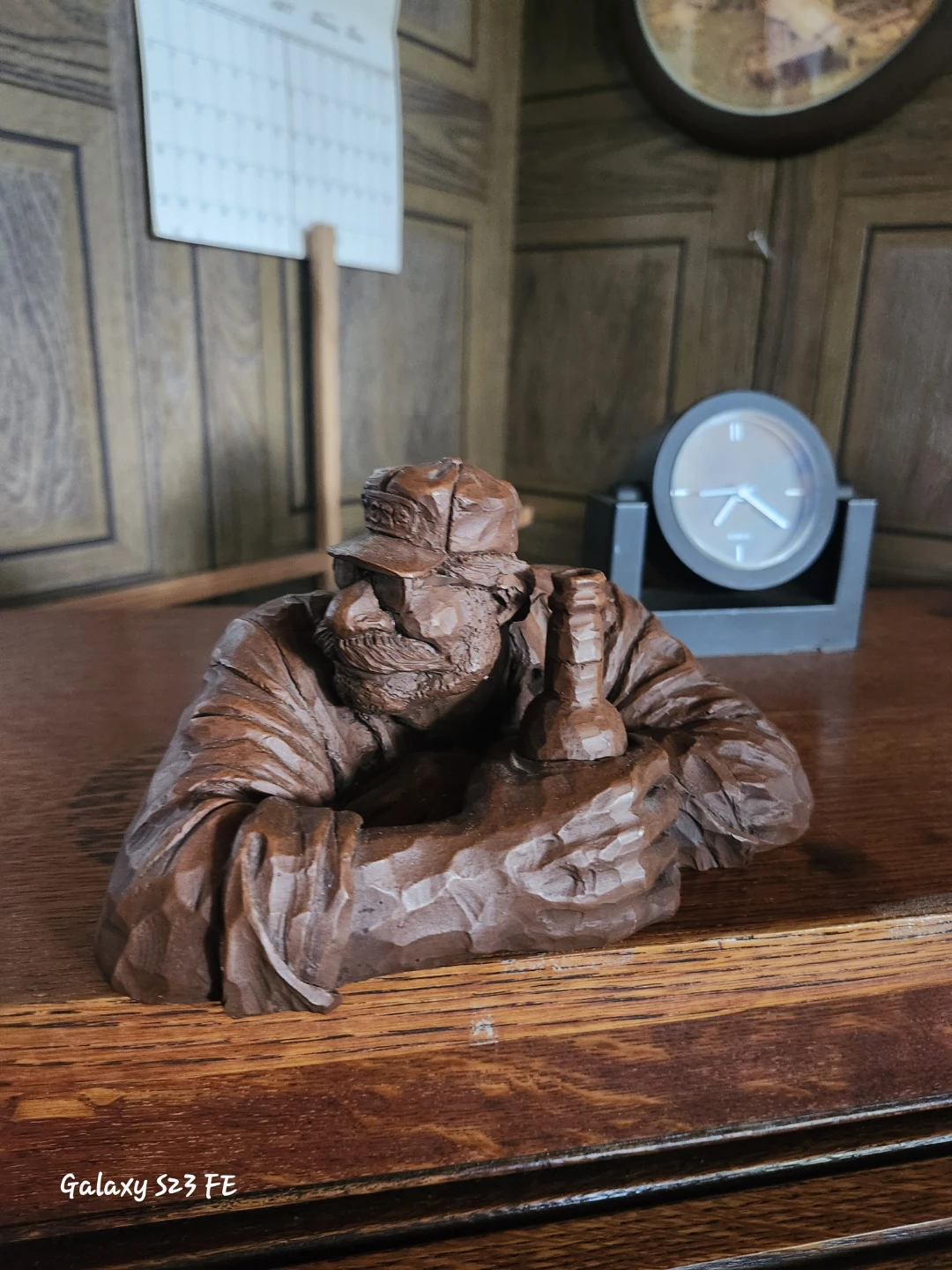 Hand Carved Wooden Figurine of a Man with a Hat and Bottle