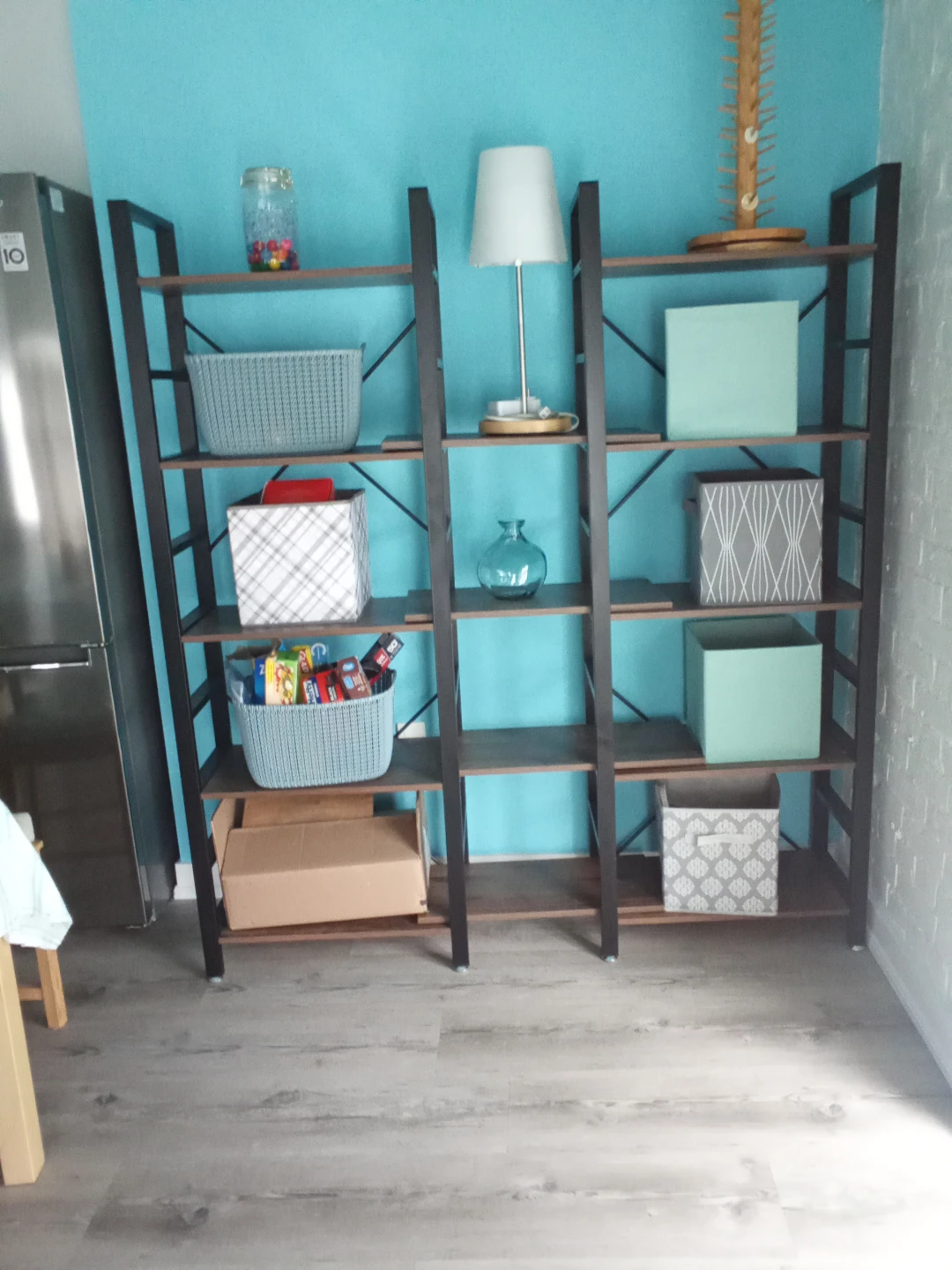 Tall metal bookshelf with wooden shelves