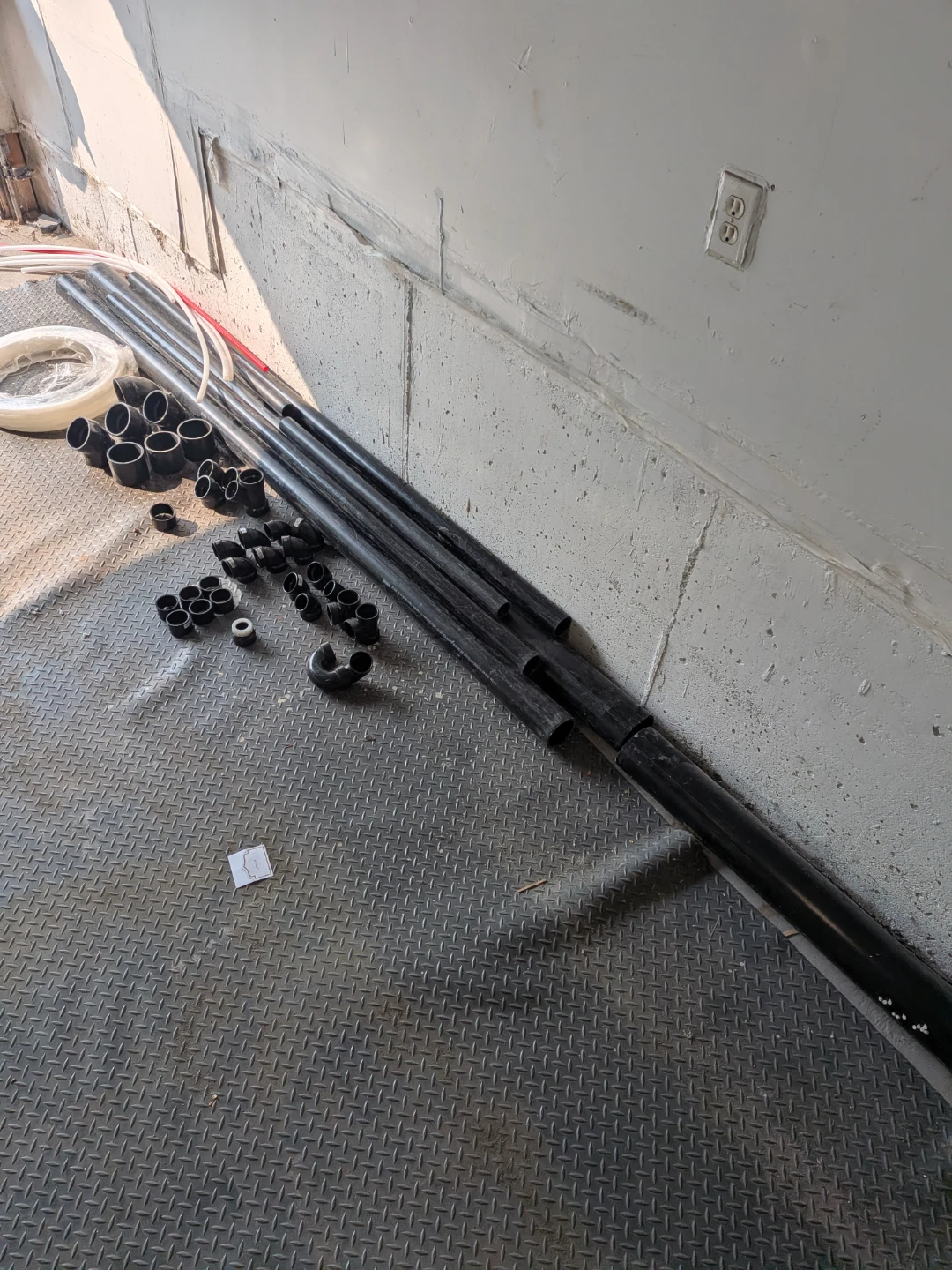 Assorted Black Plastic Pipes and Fittings