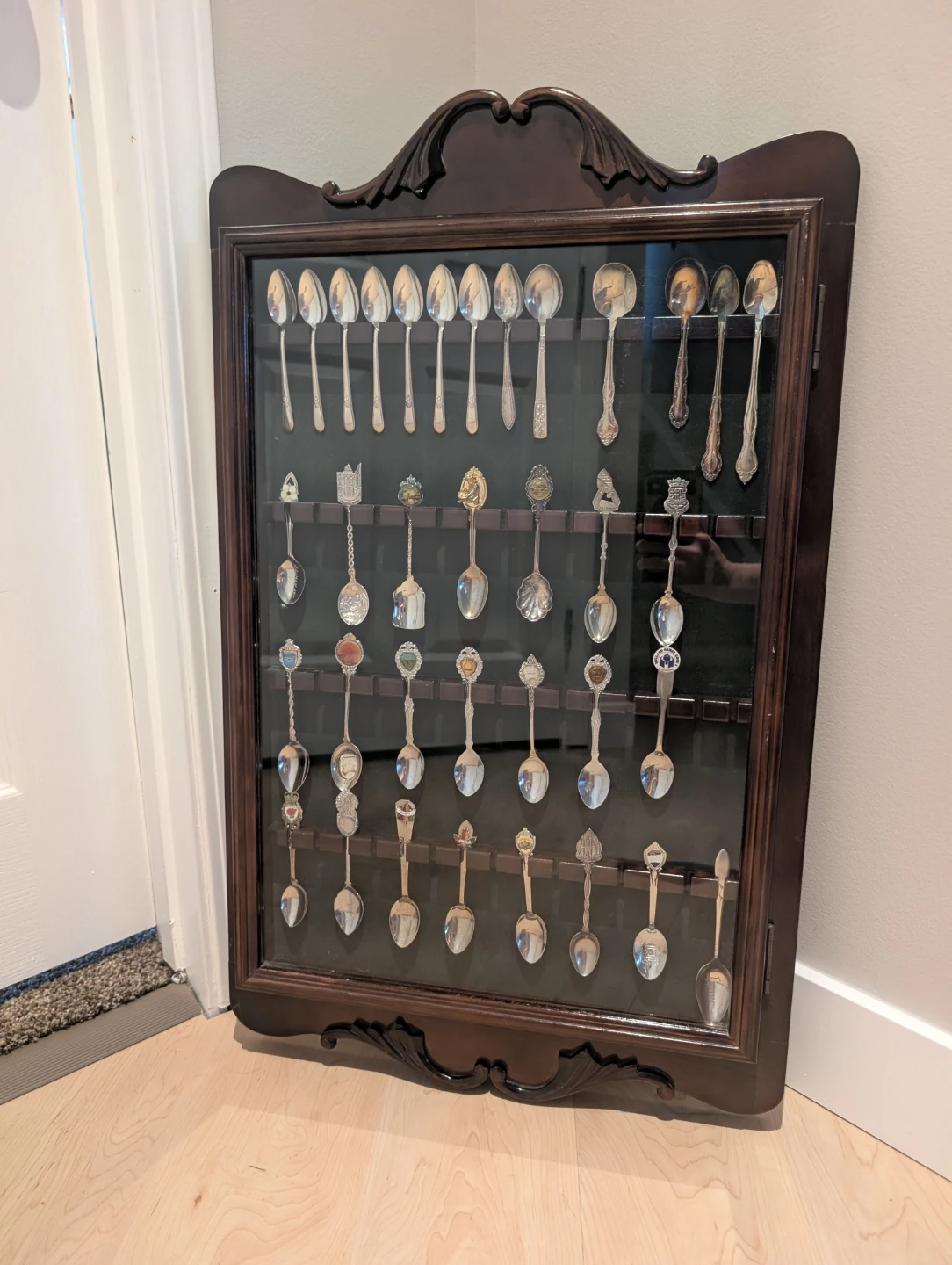 Bombay Co. Wooden display cabinet with collectors spoons