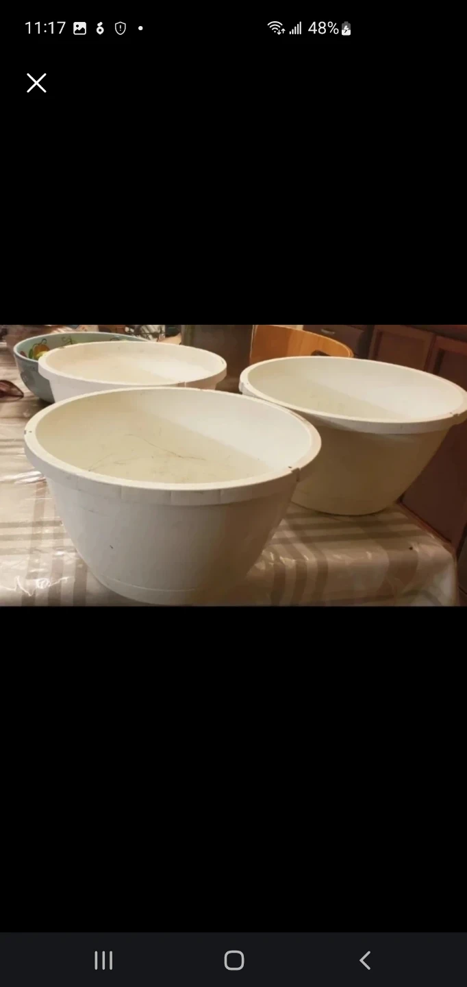 Three white plastic mixing bowls